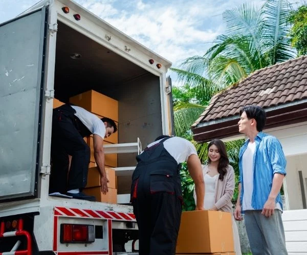 Trusted long distance movers loading household boxes with care and attention