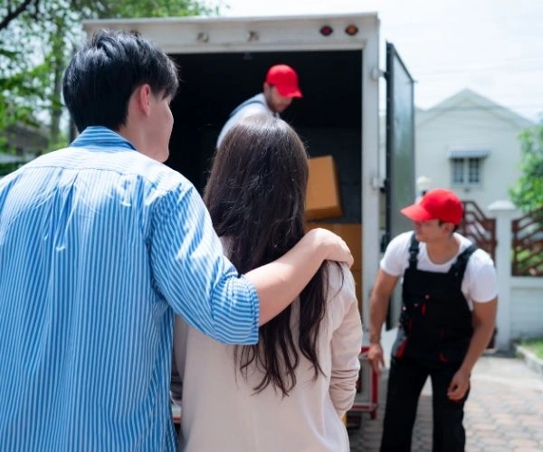 Experienced movers organizing boxes inside a moving truck during interstate moving service